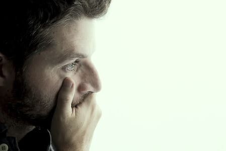 Man Leaning On Window Suffering Emotional Crisis And Depression young attractive man leaning desperate on window glass at home looking worried depressed thoughtful and lonely suffering depression in work or personal problems concept with copy space - euphoric recall