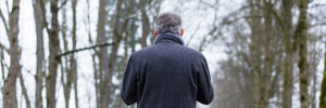 man walking alone in the woods