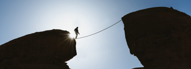 Man balancing on tightrope