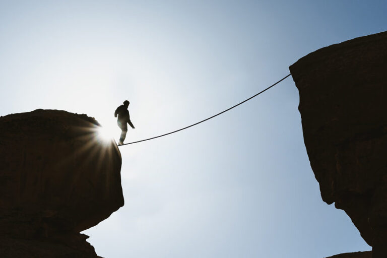 Man balancing on tightrope