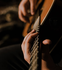 man playing his new acoustic guitar