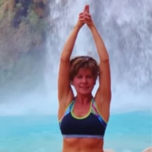 donna foster in yoga pose near waterfall